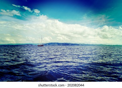 Yacht sailing in Adriatic sea near island with hills