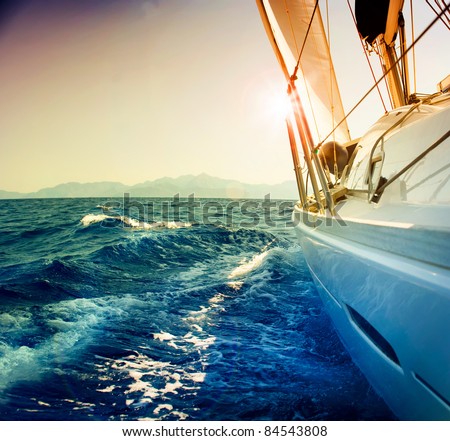Yacht Sailing against sunset.Sailboat.Sepia toned