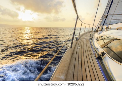 Yacht Sailing Towards The Sunset