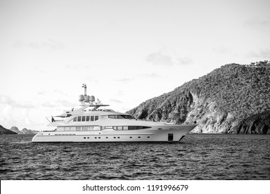 Yacht At Sea Coast On Sunny Blue Sky In Gustavia, St.barts. Yachting And Sailing Adventure. Luxury Travel And Voyage On Boat. Summer Vacation On Tropical Island. Water Transport And Marine Vessel.