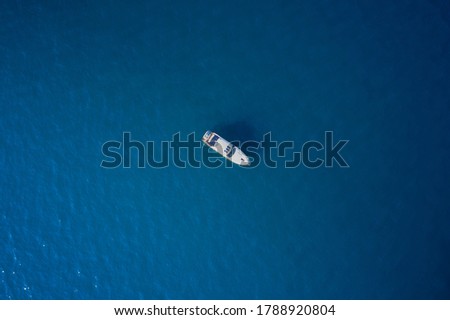 Yacht at the sea in Europe. Top view from drone of yacht. Large white yacht on calm blue water