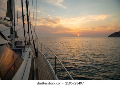 Yacht in the sea at sunset. The yacht is sailing against the background of the elegant sky