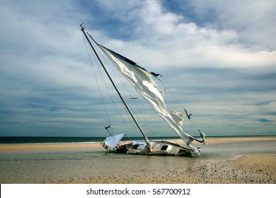 sailboat with torn sails