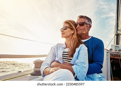 Yacht, travel and love with a mature couple sitting together on a boat out at sea for a romantic date. Luxury, ocean or summer with a married man and woman on a ship to relax during a trip - Powered by Shutterstock