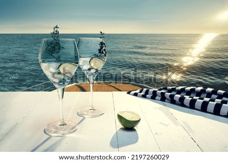 Yacht trip. Glasses with fresh lemonade, cocktail with cucumber on deck of luxury cruise ship during honeymoon holidays, outdoors. Love, travel, vivid impressions. Design for wallpaper, poster