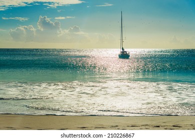 Yacht at tropical sandy beach at sunset. Anse Georgette, Praslin island, Seychelles - vacation background