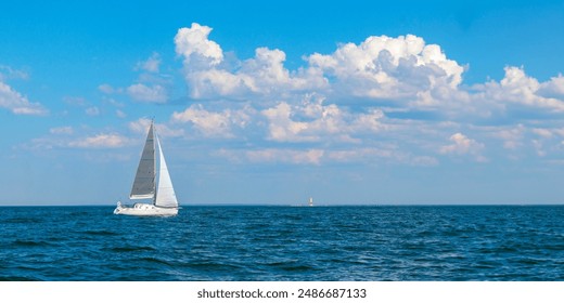 Yacht, white sailboat under head genoa and main sails sailing in an calm open sea. Cruise, vacations, regatta, sport. Gulf of Finland