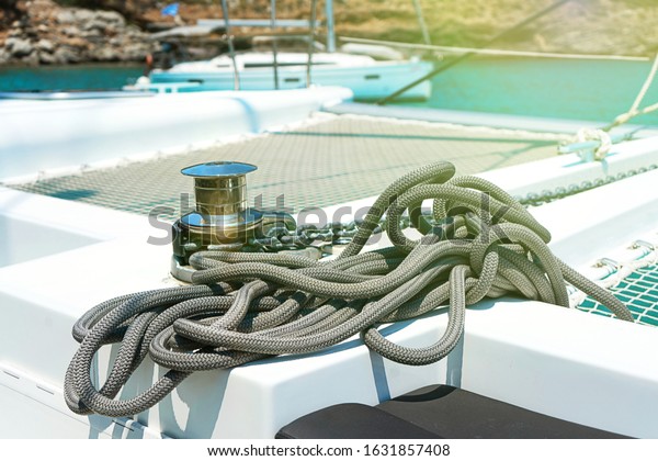 Yacht winch\
and cable on a sailing yacht. Rope wound on the small windlass of\
the yacht ship. Greece\
holiday.