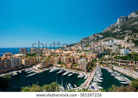 Yachts moored near city Pier, Jetty In Sunny Summer Day. Monaco, Monte Carlo architecture.