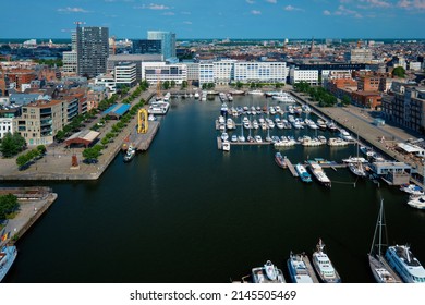 Yachts at the oldest harbor district of Antwerp city called Eilandje. Used as a yacht marina with waterfront promenade, Antwerp Province, Belgium