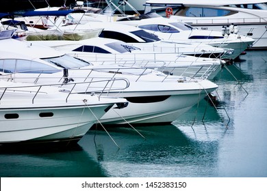 yachts and speed boats at harbor. yachts moored in the port. Ocean Coast pier. High class lifestyle. Yachting. Expensive toys. Sea ​​transport. Journey. Yachting sport. Expensive yachts at the pier.