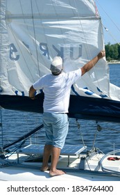 Yachtsman Setting Sail Of Yacht Before Race