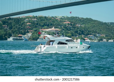yacth trip in Istanbul city  cruise, passing under the suspension bridge in on strait, marmara sea, marine traffic, cityscape trees forest of Besiktas district at background