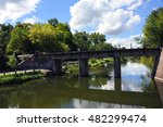 Yahara River flows beneath the train tracks along the Cooper Causeway in Stoughton, Wisconsin.