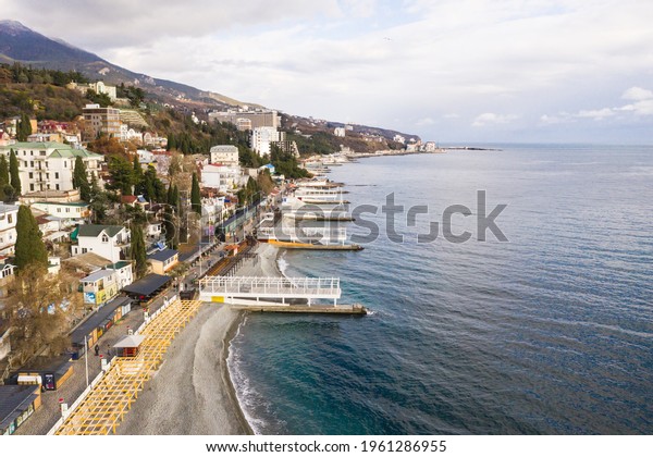 Yalta. Crimea. Winter 2020.\
Yalta samostroy from the embankment side. Coastal houses of the\
southern resort. The most well-maintained embankment of Yalta for\
2020.