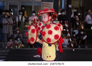 Yamagata City, Yamagata, Japan- August 7, 2022: A young Hanagasa Dancer holding the traditional hanagasa hat during  a festival in Yamagata City, Japan.
