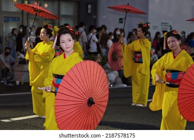 Yamagata City, Yamagata, Japan - August 7, 2022: Japanese women in traditional costumes holding umbrellas while marching in a parade.