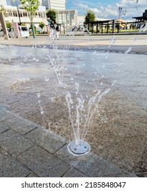Yamagata City, Yamagata, Japan - July 31, 2022: A fountain shooting up water on a city sidewalk during the summer months.