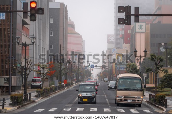 YAMAGATA, JAPAN -November 4,2018:Cars on Yamagata\
City Road, Not many cars on the road in the morning with the fog of\
winter.Cars on roads in\
Japan.