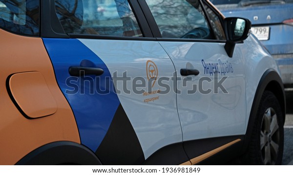 Yandex Drive logo text in russian on car in\
MOSCOW - March, 2021. Russian carsharing company Yandex Drive this\
is system of short-term car rental, economy and collaborative\
consumption,\
self-driving.