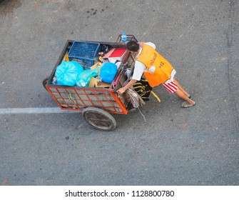 Yangon, Myanmar - 19/02/2018: A Recycling Worker Collects Plastic And Other Waste In The Streets Of The City.