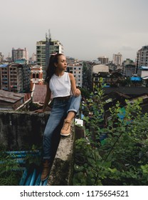 Yangon / Myanmar - August 24 2018: Burmese Model Exploring Rooftops And Container Yards.