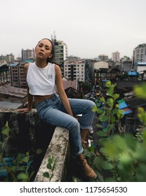 Yangon / Myanmar - August 24 2018: Burmese Model Exploring Rooftops And Container Yards.