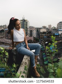 Yangon / Myanmar - August 24 2018: Burmese Model Exploring Rooftops And Container Yards.