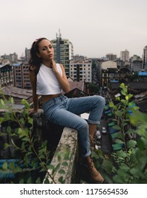 Yangon / Myanmar - August 24 2018: Burmese Model Exploring Rooftops And Container Yards.