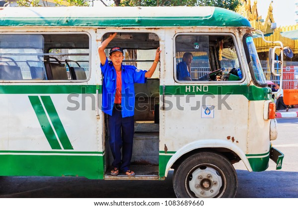 YANGON,\
MYANMAR - DECEMBER 19, 2014 :  Bus ticket officer at Bandula Bus\
terminal near Sule Pagoda, Yangon,\
Myanmar.