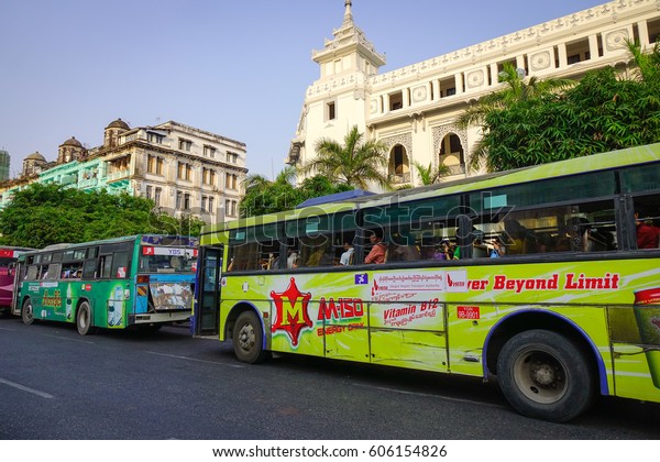 Yangon, Myanmar - Feb 13, 2017.\
Public buses run on main street in Yangon, Myanmar. Yangon is the\
largest city in Myanmar, one of the best places to visit in\
Asia