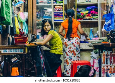 Yangon, Myanmar - FEB 19th 2014: Women In A Cloth Shops Stall Of Bogyoke Aung San Market