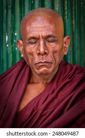 YANGON, MYANMAR - JANUARY 3, 2014: Portrait Of Ascetic Buddhist Monk Meditating In Shwedagon Paya Pagoda