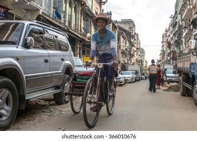 YANGON, MYANMAR - JANUARY 3, 2016: Unidentified man riding a trishaw on the streets of Yangon , Myanmar on January 3, 2016