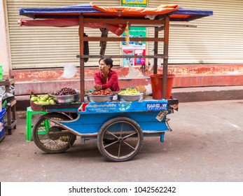 YANGON, MYANMAR - JANUARY 4, 2018: Unidentified Woman Selling Food On The Street In The City Center.  