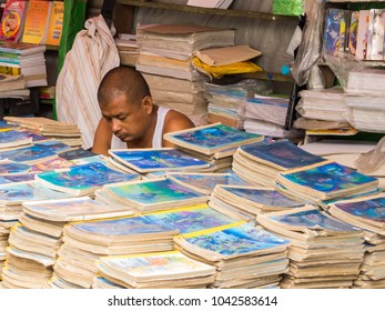 YANGON, MYANMAR - JANUARY 4, 2018: Man Selling Books On A Street In The City Center.  