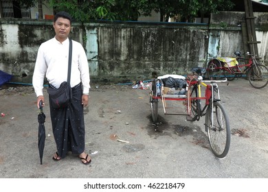 YANGON, MYANMAR - JULY 23, 2016 : Tricycle with driver, a popular vehicle in Yangon, Myanmar