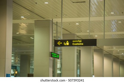 Yangon, Myanmar - June 23.2015: Yangon International Airport Customs signs with yellow signs Burmese Interior, Label Gate Yangon, Myanmar, on June 23.2015. - Shutterstock ID 507393241