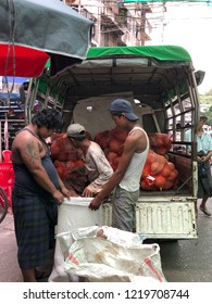 Yangon, Myanmar October 28,2018 Burmese Local Worker Are Carrying A Bag Of Coconut From The Truck.