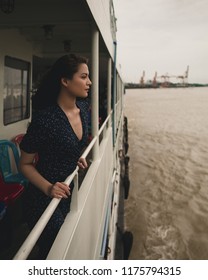 Yangon / Myanmar - September 1 2018: A Burmese Model Crossing A River On A Ship And Small Boat In Myanmar