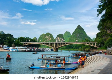 Yangshuo, China - July 27, 2018: Tourist bamboo rafts on Li river in Yangshuo near Guilin a famous travel city in southern China