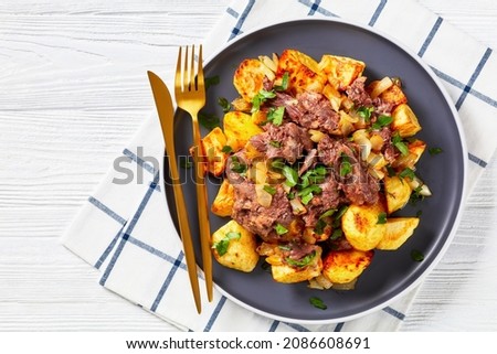 Yankee Pot Roast, Pot Roast of stewed tender beef potatoes and onion on a plate on a white wooden table, american cuisine, flat lay, free space, close-up