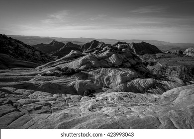 Yant Flat Cliffs - Red Cliffs National Conservation Area Near St. George, Utah - Colorful Wave Of Red Rock Formation With The Sum Skipping Off The Surface Early In The Morning - Black And White