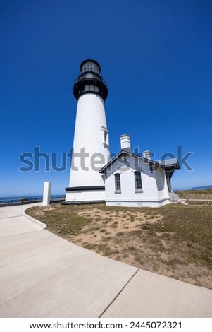 Yaquina Head Lighthouse against blue sky, along Pacific coast in Oregon state, USA.
