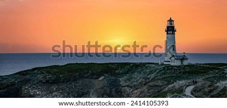 The Yaquina Head Lighthouse with a blue and pink sunset at Newport, Oregon.