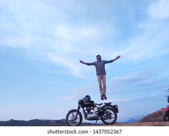 Yarcaud, India - May 12, 2019 : Rider jumping in air from the Royal Enfield motorcycle