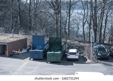 in the yard of a hospital, two waste compactors stand side by side - Powered by Shutterstock