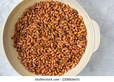 Yard Long Bean Seeds In A White Cup, Also Known As Asparagus Bean Or Snake Bean Or Chinese Long Bean, Protein Rich Vegetable Seeds On White Textured Surface, Taken From Above With Copy Space