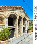 At the yard of Moni Panagias Keras under the blue Greek sky - Where the candles are lit - Beautiful clay pots with fern plants - The monastery celebrates the birth of Mary on September 8th every year