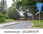 yard of a new private house with an orange car near the house